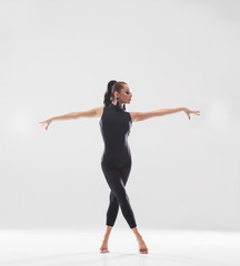 Fototapeta premium Young beautiful ballet dancer isolated over white background