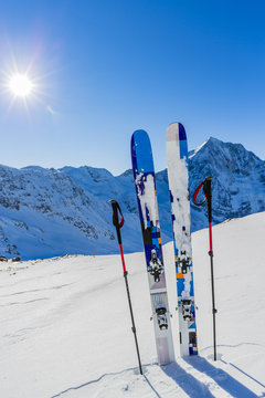Ski in winter season, mountains and ski touring backcountry equipments on the top of snowy mountains in sunny day. South Tirol, Solda in Italy.