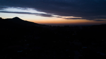 Aerial drone view of beautiful sunset sky above tropical island
