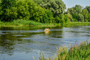 Two men in a canoe floating down the river.