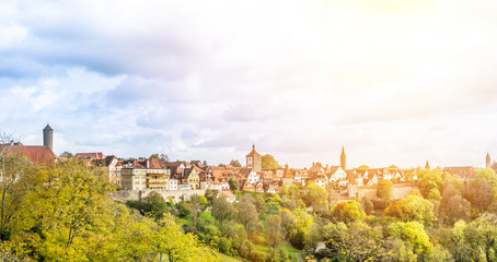 Fototapeta na wymiar Europe culture concept - panoramic city skyline birds eye aerial view under dramatic sun and morning blue cloudy sky in Rothenburg, Germany