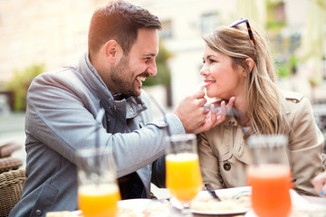 Couple eating pizza snack outdoors.