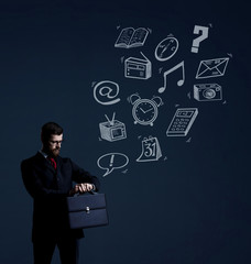 Businessman with briefcase checking time over dark dramatic background. Business and office, concept.