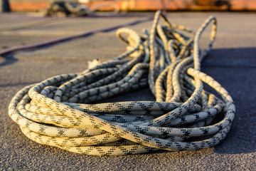 Fototapeta premium Close up braided climbing rope on asphalt
