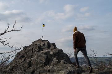 Young man hiking to top of Goethekopf mountain between Spitzkunnersdorf and Leutersdorf in Germany
