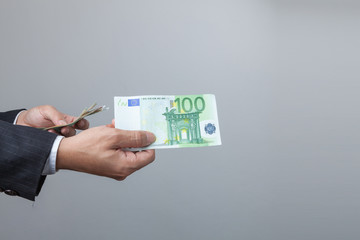 Business man holding bank notes.