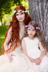 The red-haired girl with the baby, daughter or sister. Delicate and long-haired.