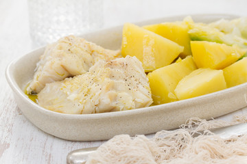 boiled cod fish with potato on dish