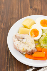 boiled fish with boiled vegetabbles on white plate