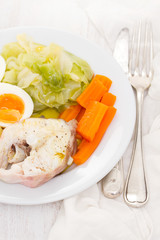 boiled fish with boiled vegetabbles on white plate