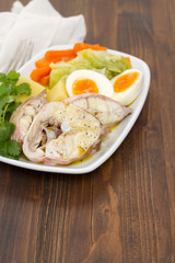 boiled fish with boiled vegetables on white plate