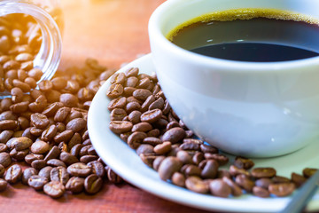 Cup of dark coffee  with coffee beans. Relax time in the morning.
