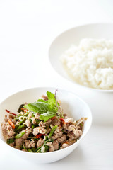 Topped with stir fried pork and basil