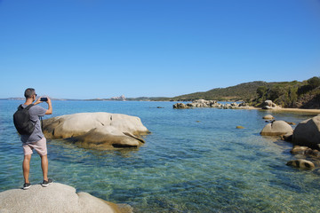 young man taking a picture in Sardinia, Italy