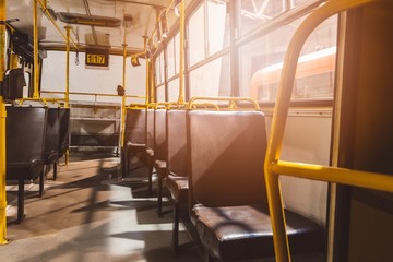 Classic brown leather seats in old city bus.