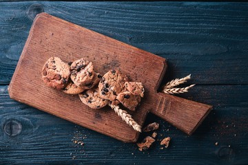 Cookies with chocolate. On a wooden background. Top view. Free space for your text.