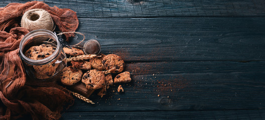 Cookies with chocolate. On a wooden background. Top view. Free space for your text.