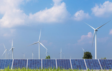 solar cells with wind turbines generating electricity in hybrid power plant systems station on blue sky background alternative renewable energy from nature  Ecology concept.   