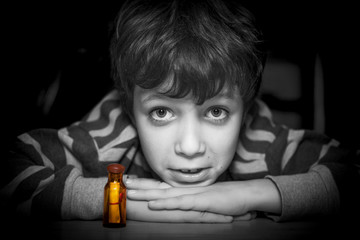 Boy trustful look and his message in a bottle, portrait.