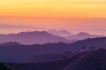 sunrise high angle view in early morning over rainforest mountain in thailand 