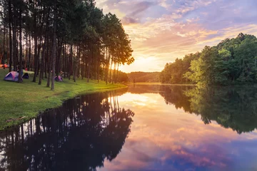 Foto op Aluminium Sunrise in early morning at pang ung lake in mae hong son,Thailand with pine trees reflection on the water selective soft focus © Soonthorn