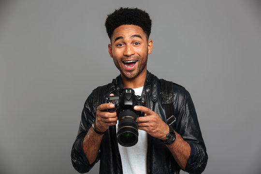 Close-up Portrait Of Happy Exited Afro American Man Holding Photocamera