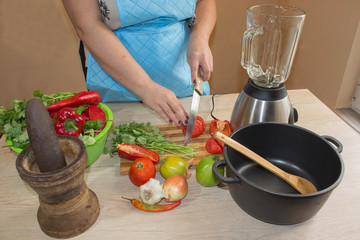 woman cooking healthy meal in the kitchen. Cooking healthy food at home. Woman in kitchen preparing vegetables
