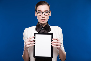 brunette in glasses with a tablet in hands