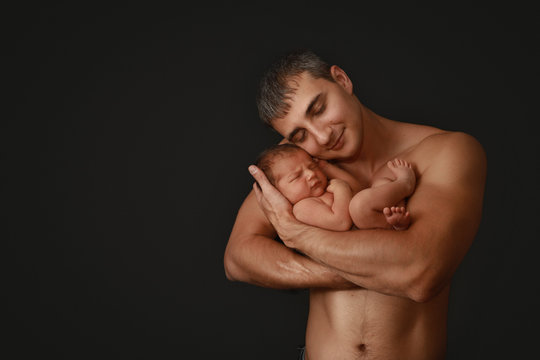 Newborn With Dad on Black Background