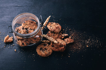Cookies with chocolate. On a wooden background. Top view. Free space for your text.