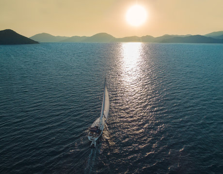 Boat sailing into the sun in Mediterranean Sea