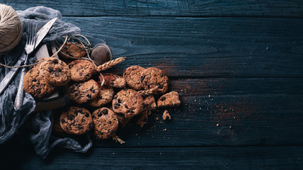 Cookies with chocolate. On a wooden background. Top view. Free space for your text.