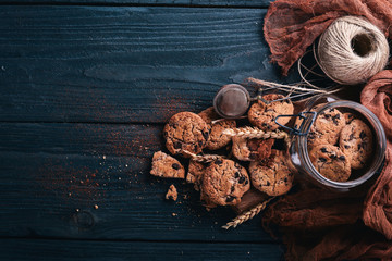 Cookies with chocolate. On a wooden background. Top view. Free space for your text.