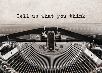 Tell us what you think message typed on old vintage typewriter. Close up