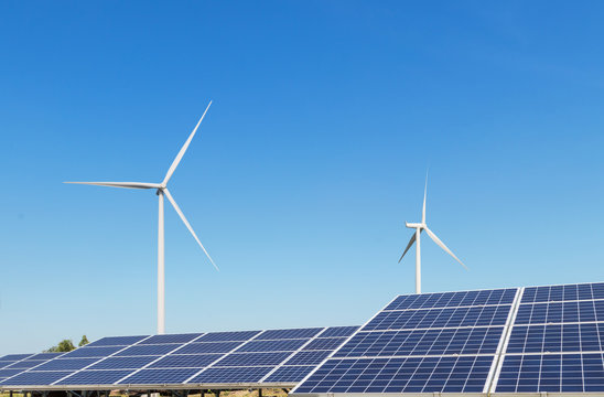 Solar cells and wind turbines generating electricity is solar energy and wind energy in hybrid power plant systems station use renewable energy to generate electricity with blue sky background 