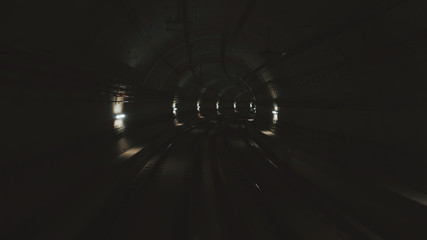 View of subway tunnel as seen from reverse of moving backward train. Fast underground train riding...