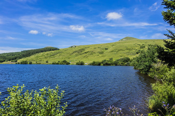 Fototapeta na wymiar View of Lake Guery. Lake Guery is a mountain lake of volcanic origin located in Monts Dore, in the heart of the Massif Central. It is the highest of the Auvergne lakes. Auvergne-Rhone-Alpes. France.