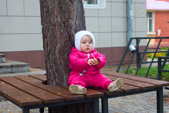 Child sitting on the branch, city lifestyle, autumn weather
