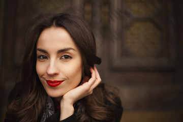 young attractive woman posing against vintage wooden door