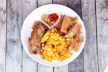 Deep fried dessert of sweet corn,tofu ,taro and  spring roll served with spicy sweet sauce.