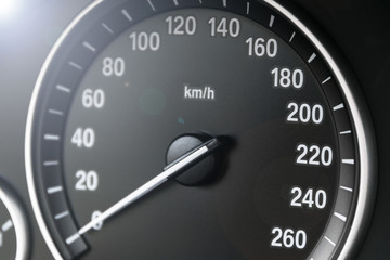 Car instrument panel dashboard closeup with visible speedometer, car interior details. Soft lighting