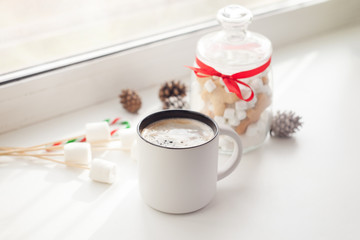 christmas, holidays, winter, celebration and still life concept - close up of cookies and cup with hot chocolate or cocoa drink on table
