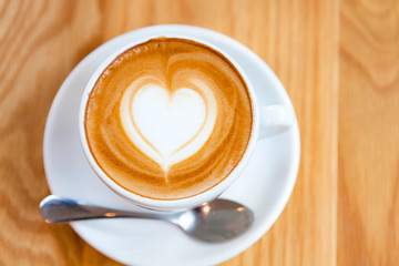 Cappuccino or Latte coffee art cup with heart shaped.