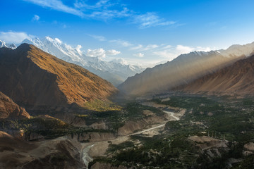 Fototapeta na wymiar Hunza Valley, famous mountainous valley in the Gilgit–Baltistan region of Pakistan. with sunshine behind the mountain.