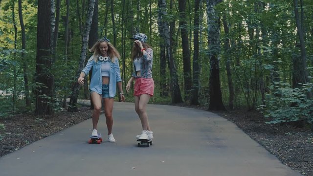 Attractive girls skating outdoors