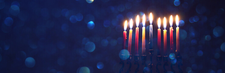 ewish holiday Hanukkah background with traditional spinnig top, menorah (traditional candelabra)...