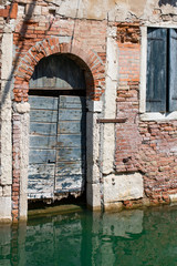Venice, Wenedig, Wenecja - an old medieval city on water, between canals. View from a sail boat or from the bridges.