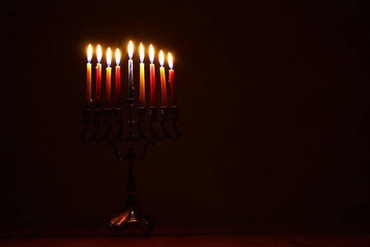 low key image of jewish holiday Hanukkah background with menorah (traditional candelabra)