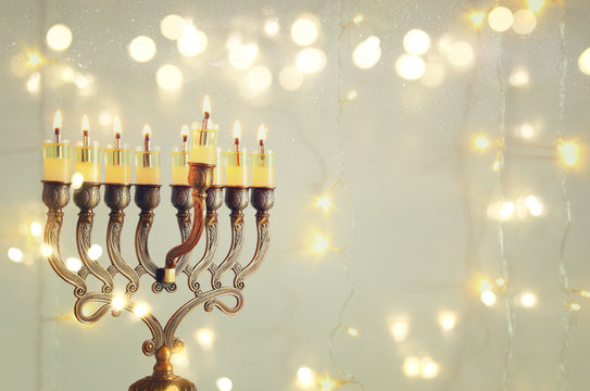 Image of jewish holiday Hanukkah background with menorah (traditional candelabra) and burning candles