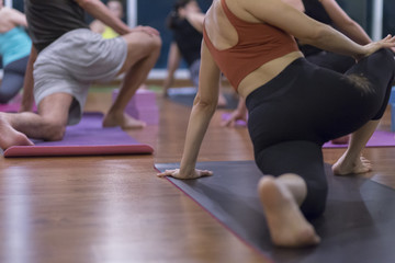 Fototapeta na wymiar Women asian exercising in fitness studio yoga classes